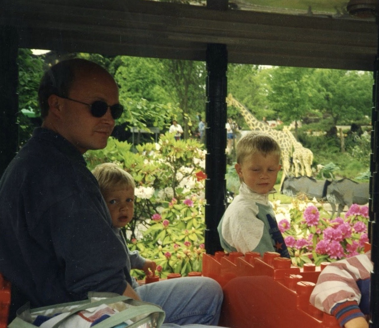 Tom Egill and Terje Otto as small boys on the Legoland train with their father, around 1995
